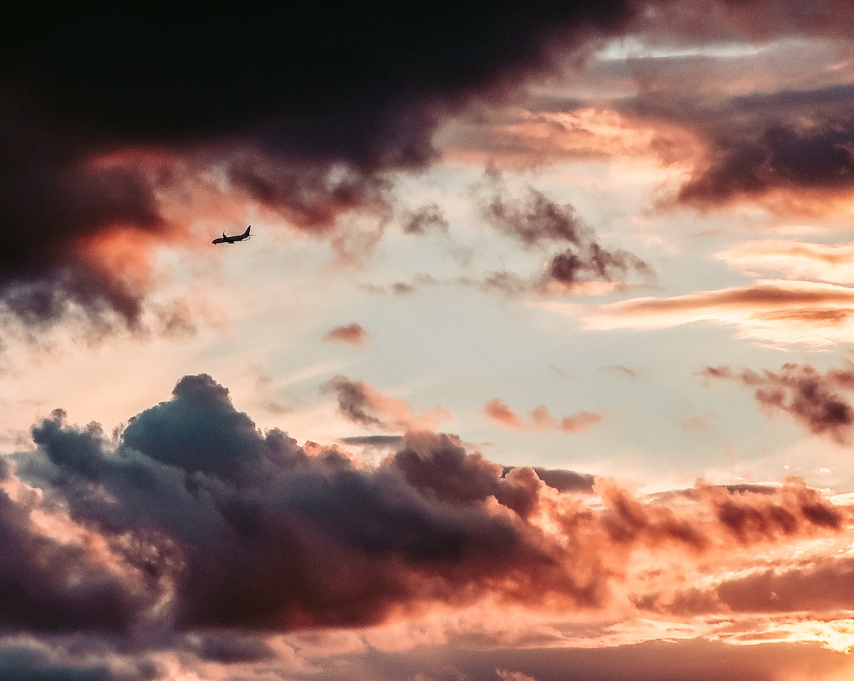 A tiny plane surrounded by dark clouds.