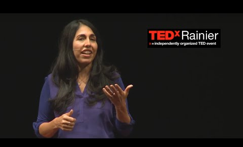 Woman presenting at a TED talk